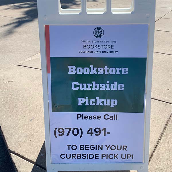 A photo of a sign that reads Bookstore Curbside Pickup.